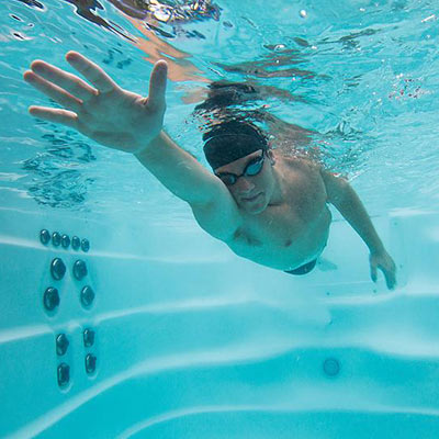 Underwater shot of man swimming in an H2X swim spa